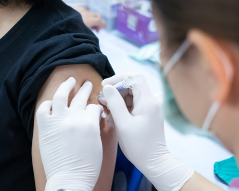 A health care worker gives a vaccine to a patient