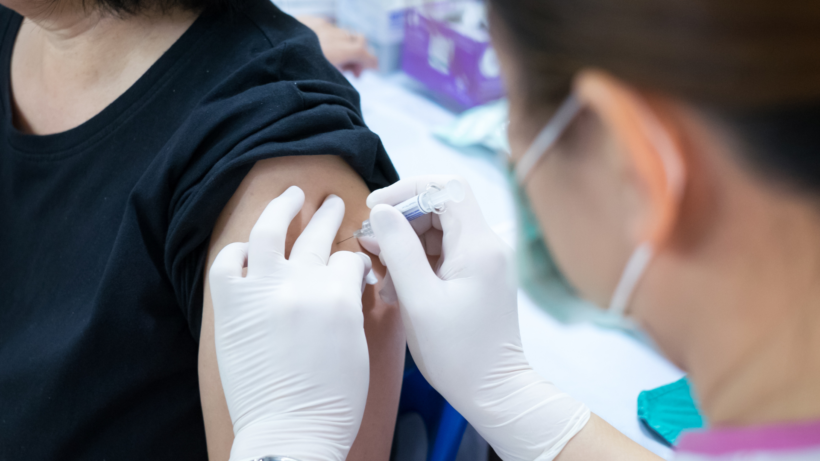 A health care worker gives a vaccine to a patient