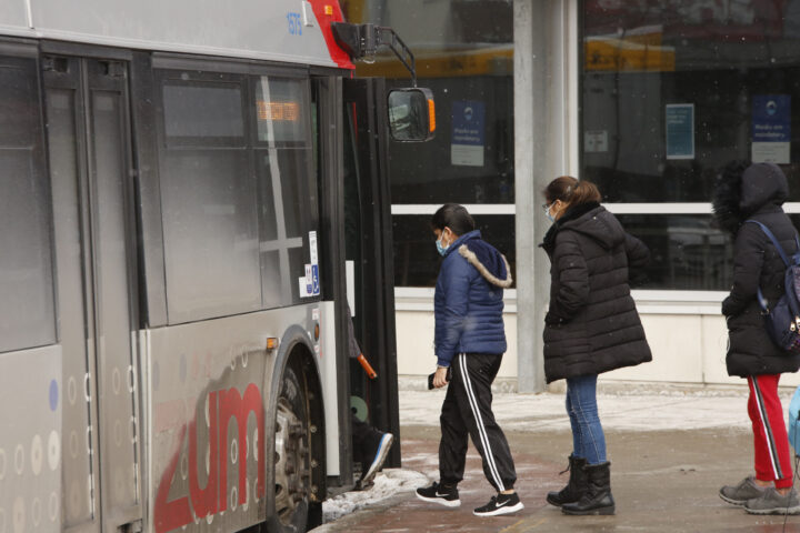 Photo of people lining up to get on a bus operated by Brampton Transit.