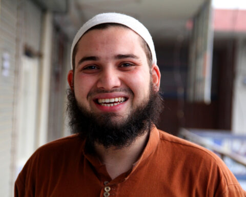 South Asian Canadian smiles at the camera