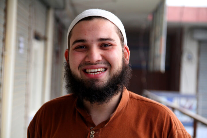 South Asian Canadian smiles at the camera