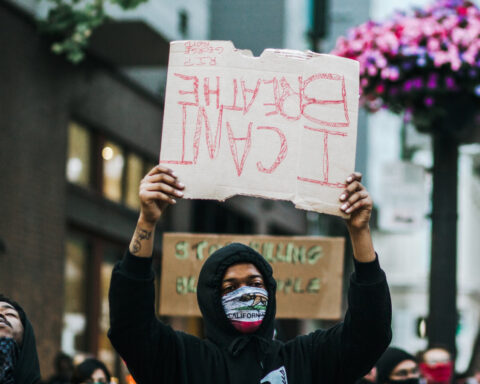 Many protests took place before the Derek Chauvin trial. Picture here is a protestor holding an upside down sign that reads "I can't breathe."