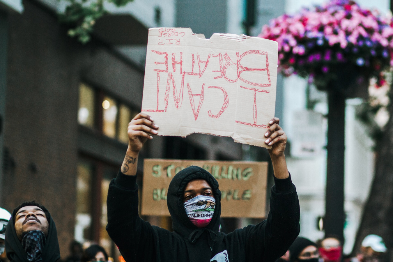 Many protests took place before the Derek Chauvin trial. Picture here is a protestor holding an upside down sign that reads "I can't breathe."