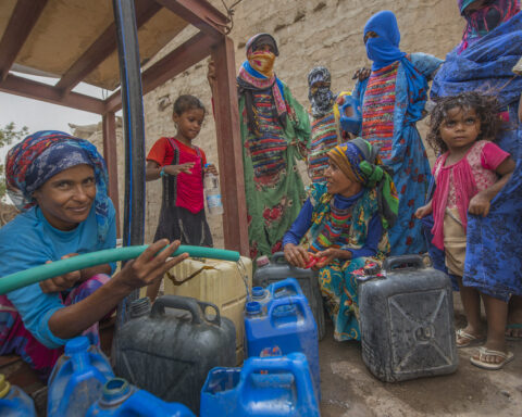 People fetch water provided by Solidarités International, an EU-supported aid group, in Yemen's Hodeida Governorate.