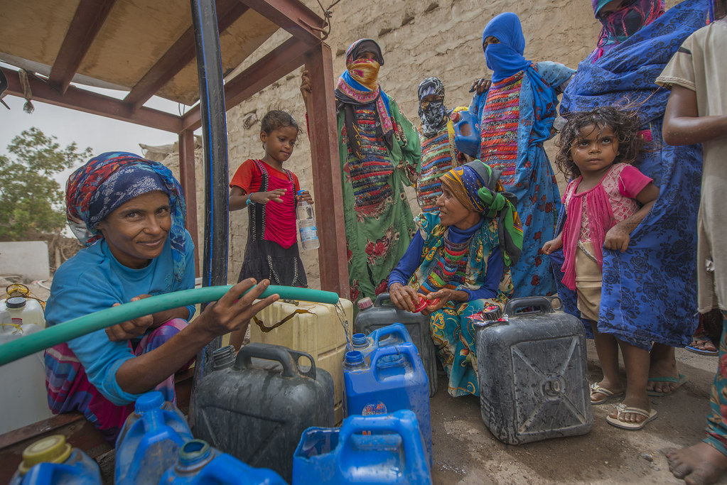 People fetch water provided by Solidarités International, an EU-supported aid group, in Yemen's Hodeida Governorate.