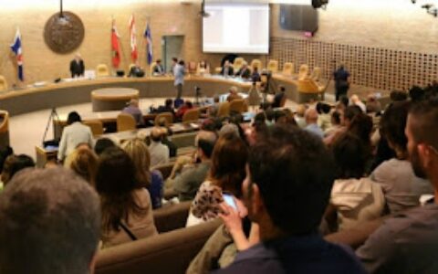 An auditorium filled with people attending an event for Iranian-Canadians in Toronto