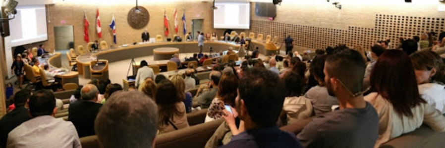 An auditorium filled with people attending an event for Iranian-Canadians in Toronto