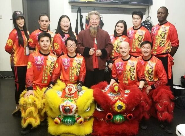 Master of Chinese Dragon and Lion Dance with teammates