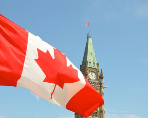 Drapeau canadien flottant devant l'édifice du Parlement sur la colline du Parlement à Ottawa.