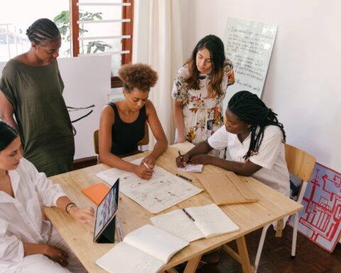 women working together around a table