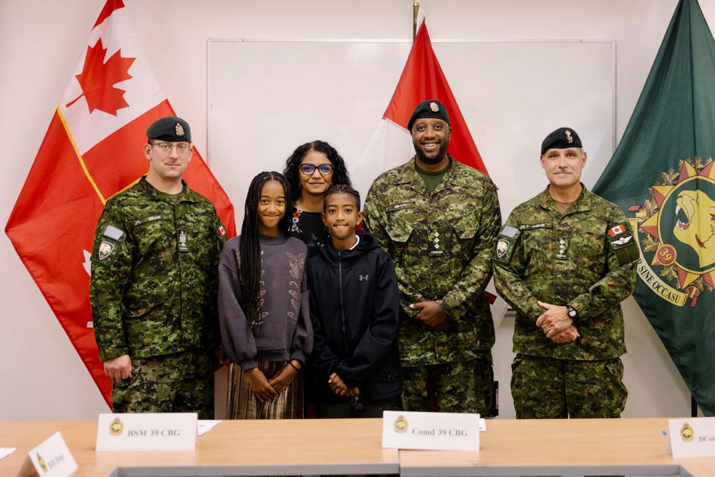 (From left to right) former Brigade Sergeant Major, Chief Warrant Officer G.R Colgan; Isabelle Mbaho, Anita Sanghara-Mbaho, Jahan Mbaho, Captain William Mbaho, and Colonel Scott Raesler the commanding officer of 39 Canadian Brigade Group in BC