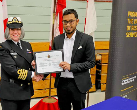 Capt. (Navy) Beth Vallis and Sailor 3rd Class Chowdhury hold up the enrollment certificate during their enrollment on March 8, 2023 at His Majesty’s Canadian Ship, HMCS, Queen Charlotte in Charlottetown, P.E.I. Chowdhury, a native of Bangladesh, became just the second Permanent Resident to enroll in this country’s Armed Forces.