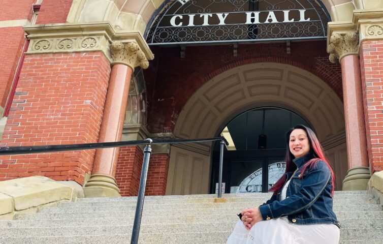 Le Farris, of Keswick Ridge, a small rural community northwest of Fredericton, in front of Fredericton City Hall. Farris fled Vietnam in the 1970s with her family by boat and started a new life in Canada. She encourages new Canadians to embrace the culture of their adopted land. (Michael Staples/New Canadian Media)