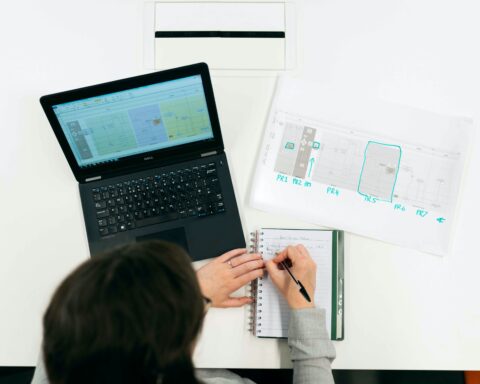 Engineer working at a desk with a computer and files