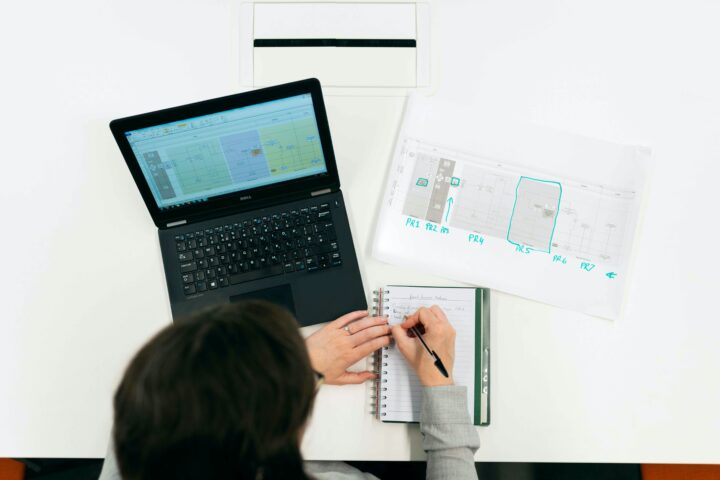 Engineer working at a desk with a computer and files