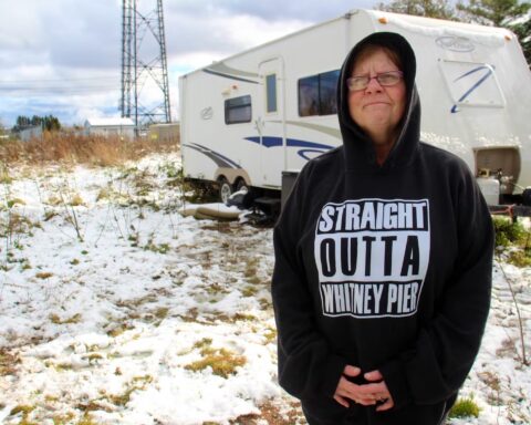 Shannon Dornadic stands outside the recreational vehicle she moved into in August, unable to find affordable housing appropriate to her needs. (Nicole Sullivan / Cape Breton Post)